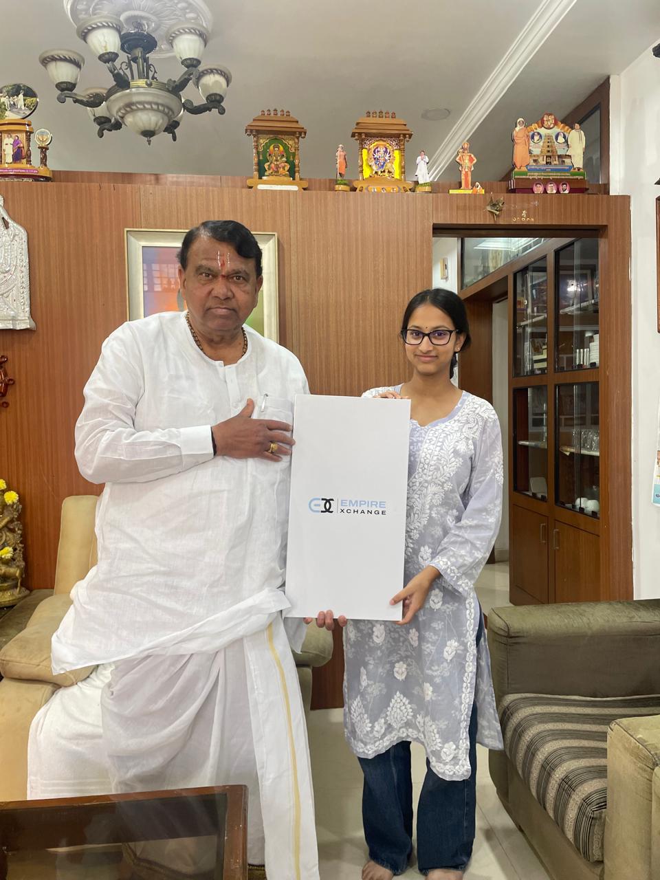 Saanvi with MLA Pocharam Srinivas Reddy holding Empire Exchange